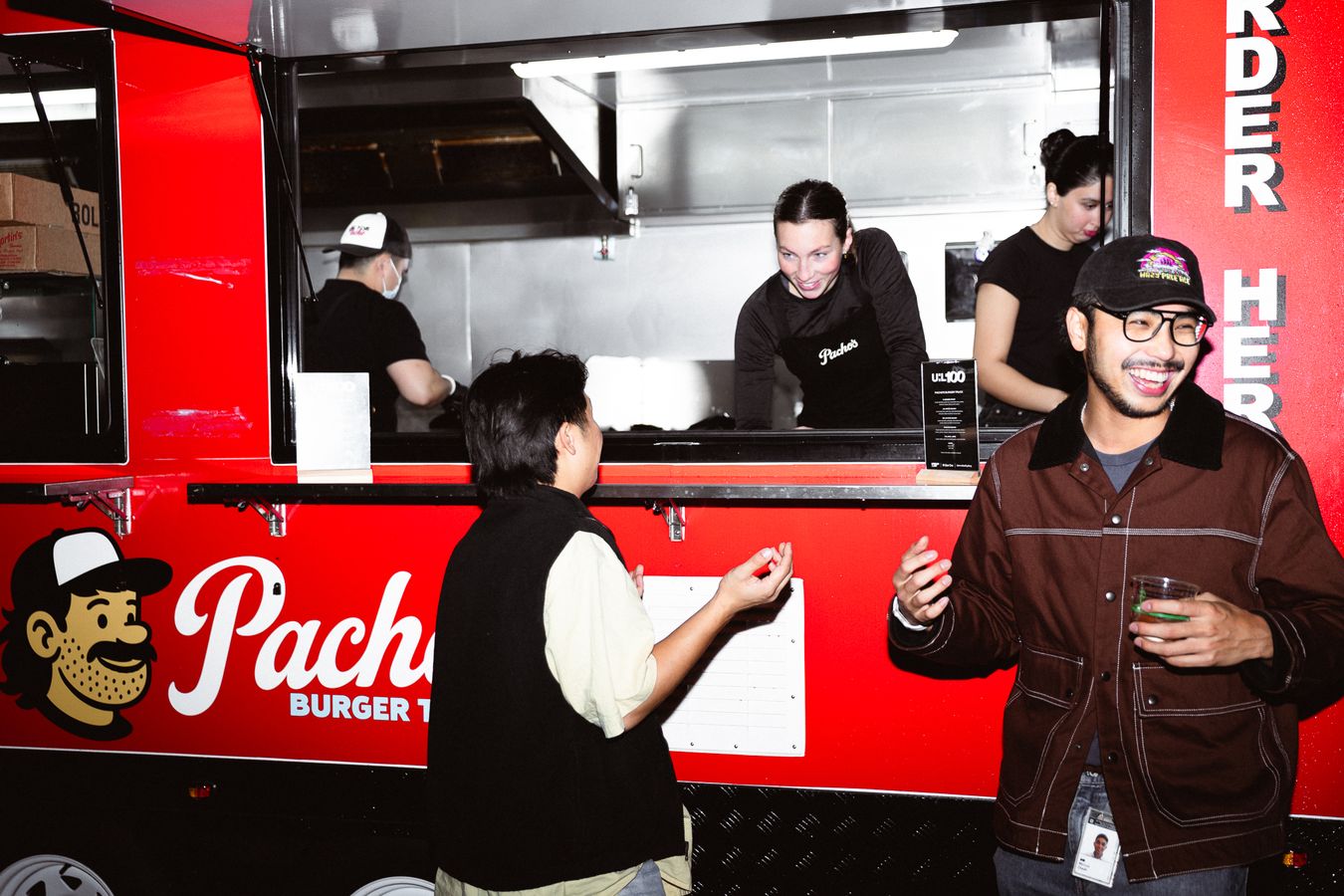 Guests ordering at the Pacho's truck window at the Urban List 100 party